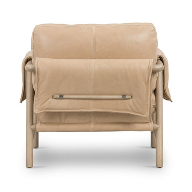 Beige leather armchair with a blanket draped over it on a white background